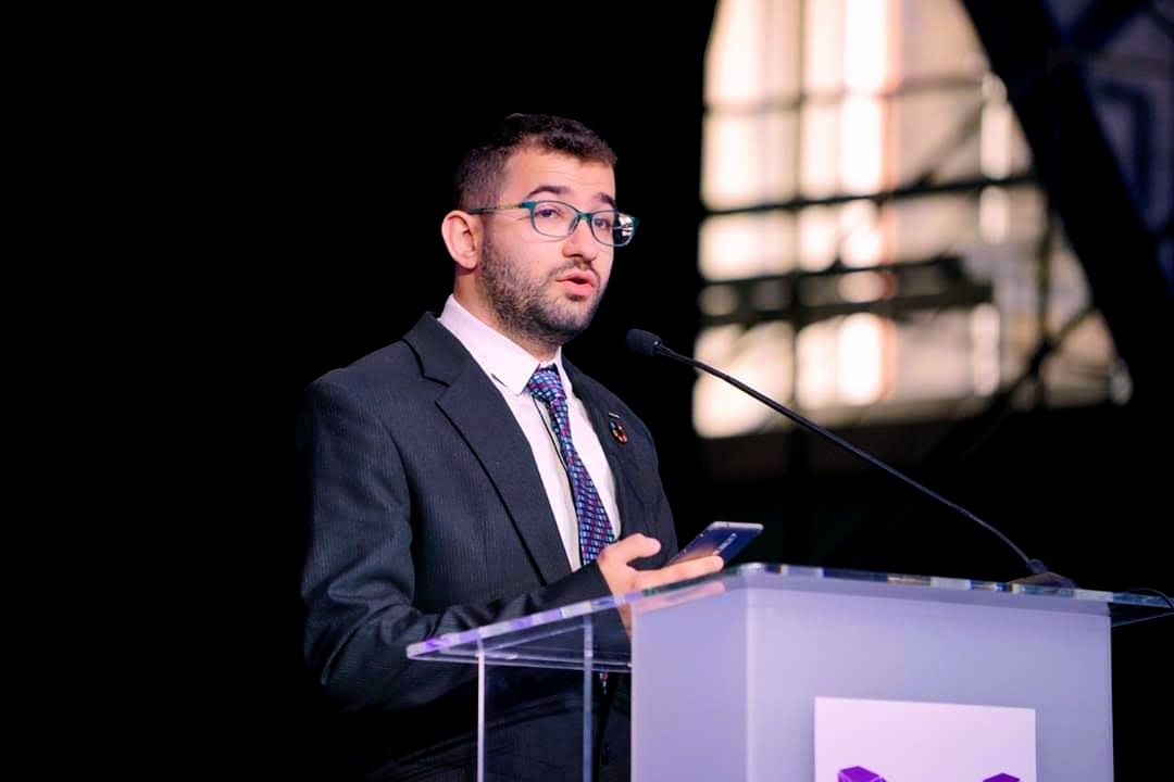 Mohammad Hijazi speaking at a conference podium